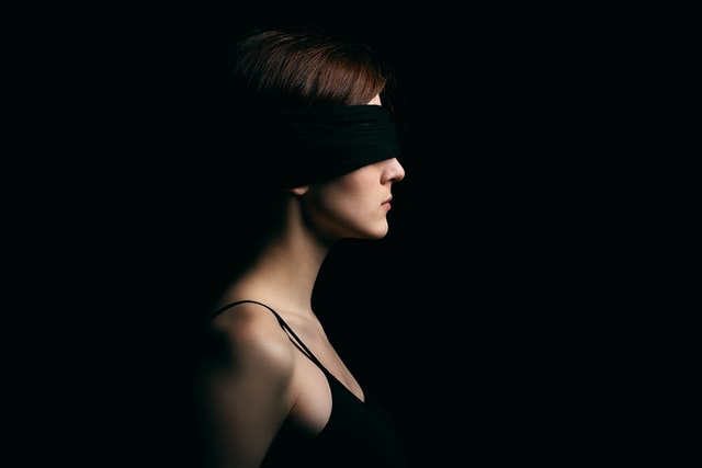 Woman with a black bandage over the eyes